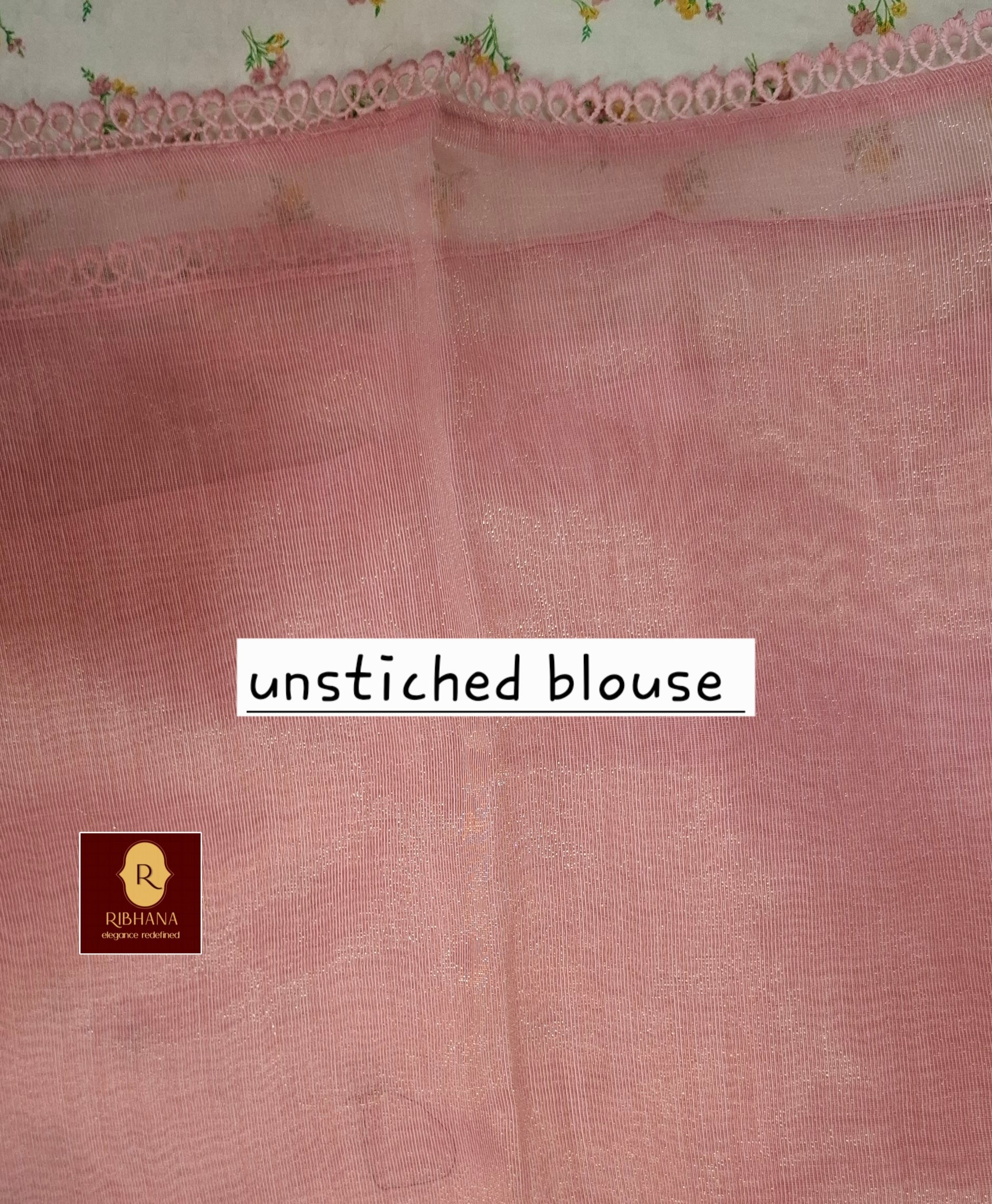 A dusty pink unstitched cotton blouse fabric with a subtle woven texture, featuring a decorative floral lace border at the top and a white text overlay reading 'unstitched blouse'. A small brand logo for Ribhana is visible in the bottom-left corner.
